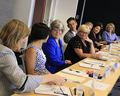 members sit around a table at a Consortium meeting