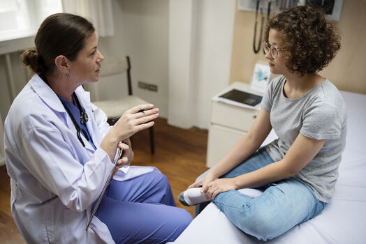 Doctor talks to young woman patient