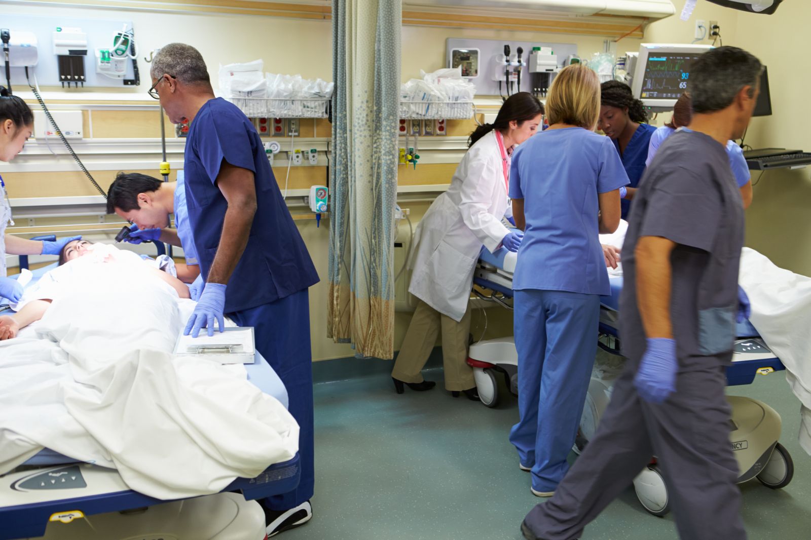nurses working at two hospital beds